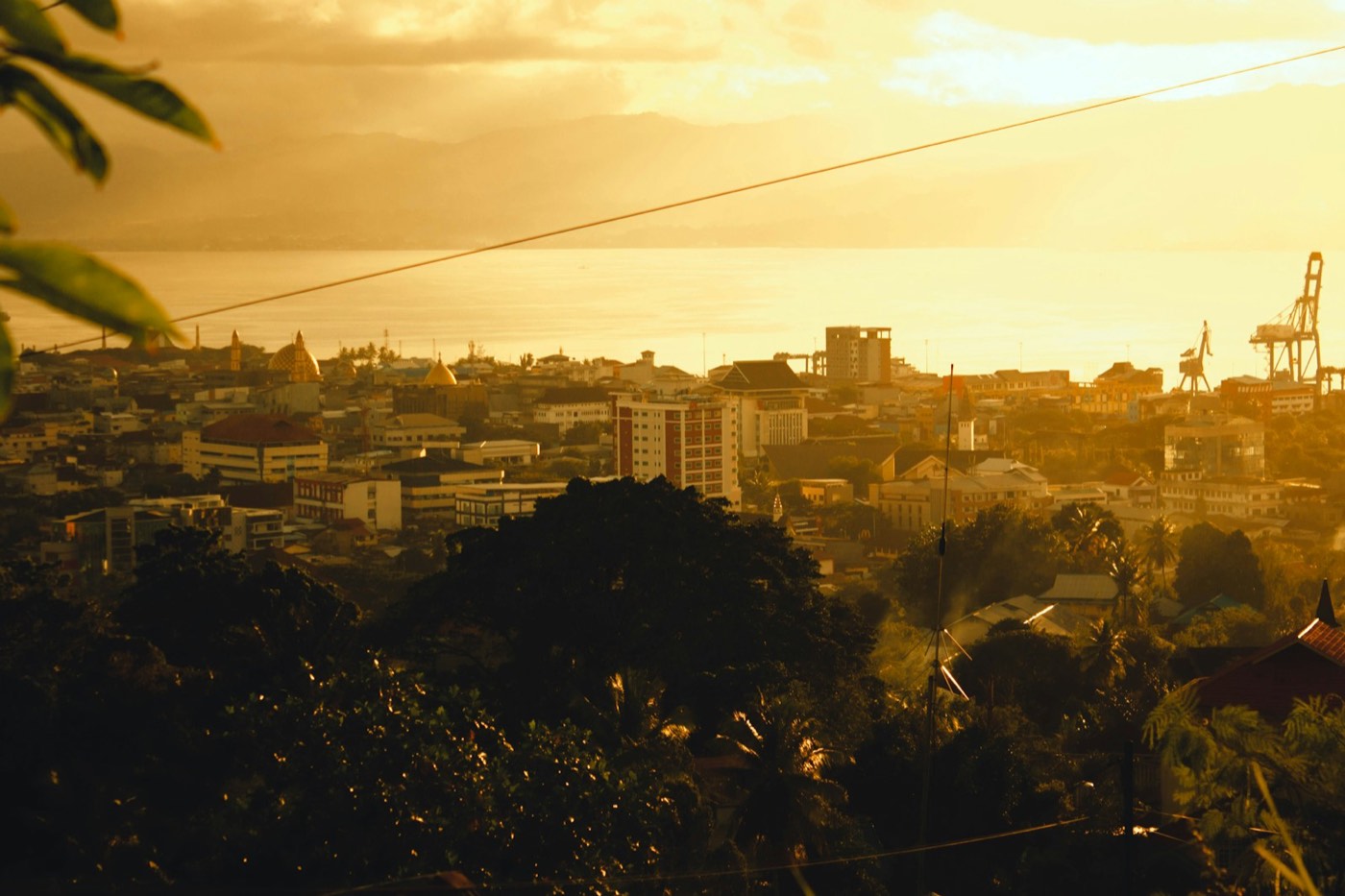 Ambon city skyline at golden hour over the harbour